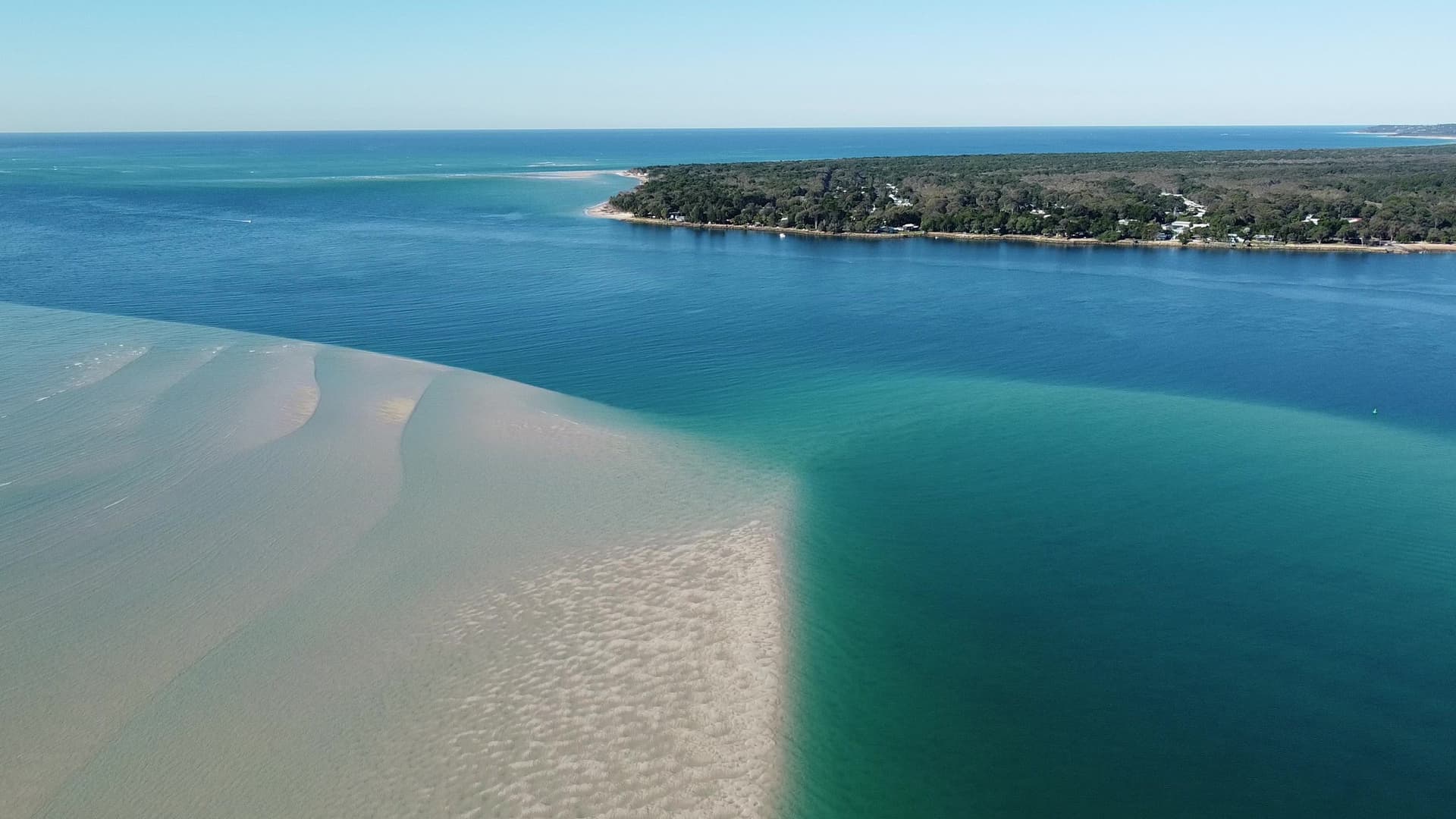 High aerial of the Amity sandbanks where pale sand meets a deep emerald channel