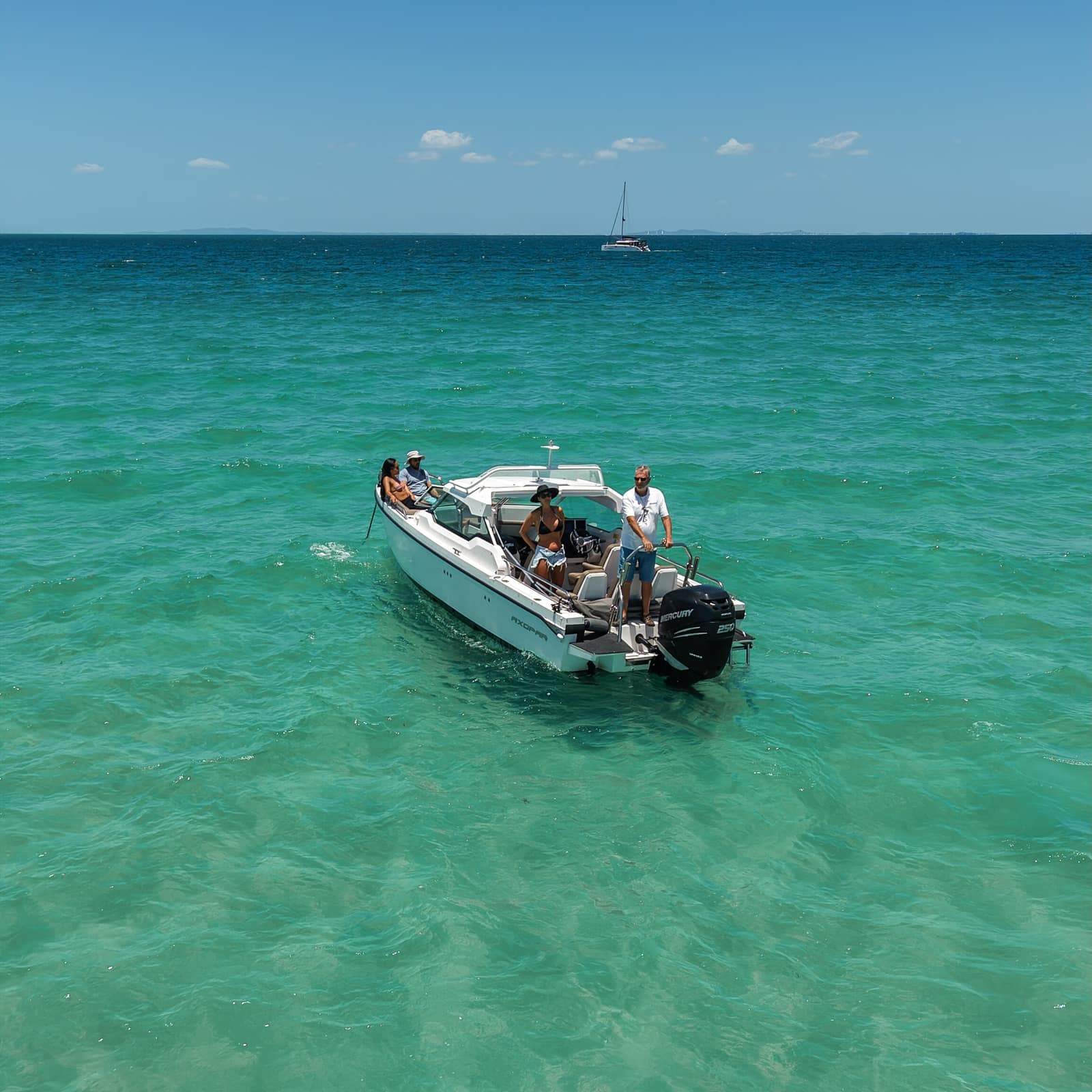 The Axopar 24 anchored off a secluded Moreton Bay sandbar, seen from above